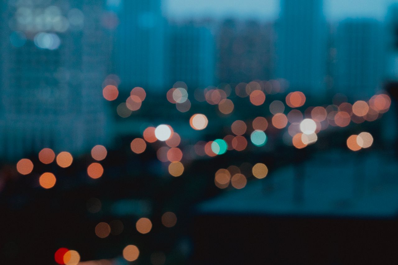 Soft-focus cityscape showcasing colorful urban lights with a dreamy bokeh effect.